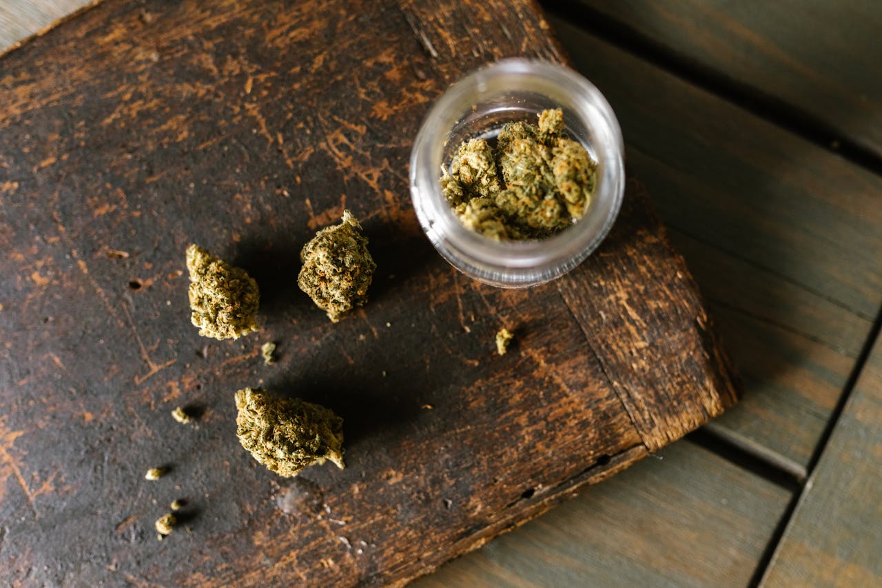 High-Angle Shot of Marijuana on Wooden Surface